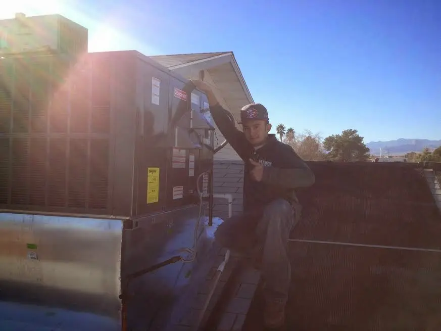 HVAC technician performing Boiler Repair on a rooftop unit in Druid Hills